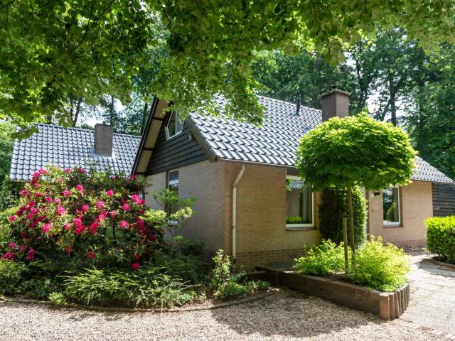 Beautiful house with a fireplace in a holiday park in the woods