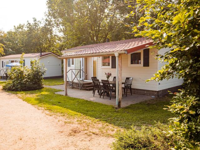 Nice chalet with covered terrace at a holiday park on the Leukermeer