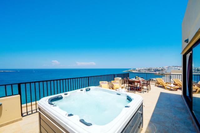 Islet Promenade Seafront Penthouse with breathtaking seaviews and private hot tub on the large terrace by Getawaysmalta