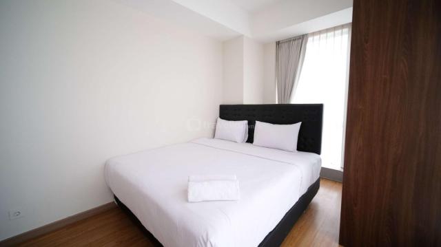 Simple and Clean 2BR at Grand Sungkono Lagoon Apartment By Travelio