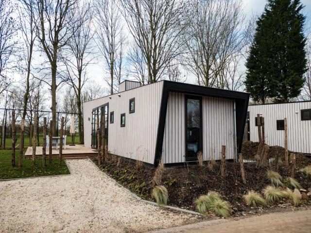 Modern chalet by the river Maas