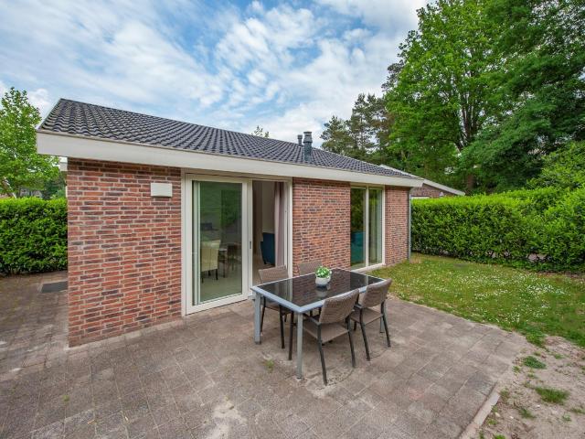 Modern bungalow with washing machine in green surroundings